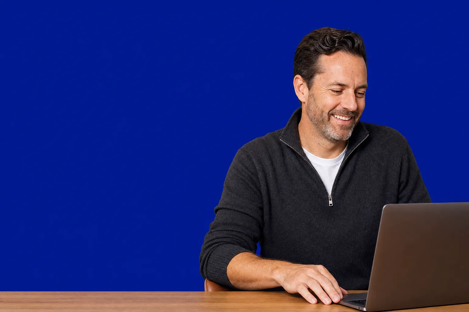 A broker working at a laptop